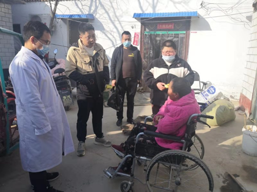 图为：县残联群工部部长王闯带队为鲁河镇残疾人上门办理残疾证现场