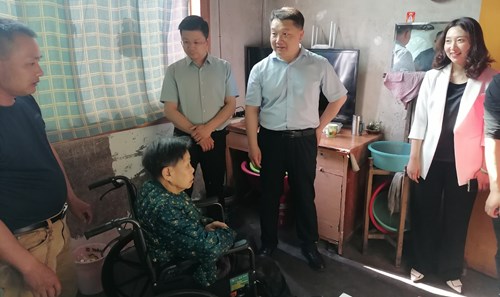 图为县领导慰问残疾人